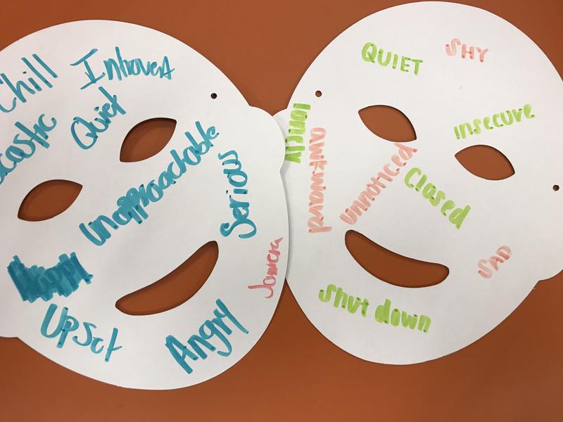 Two paper masks with handwritten messages